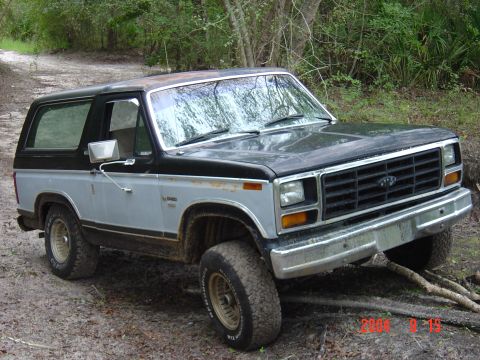1982 Ford Bronco - This 1980 Ford Bronco is shown in a three-quarter front view while navigating an off-road trail.