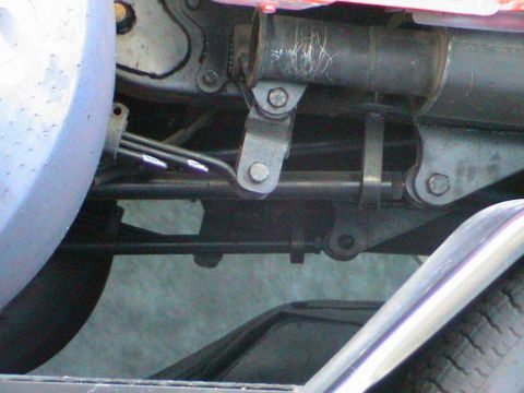 1979 Ford Bronco - Undercarriage view shows mechanical linkages and suspension components of a vehicle.