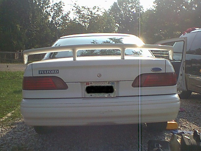 Rear of a white sedan with a large spoiler and 'FULFORD' badging