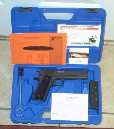 1995 Ford Bronco - A Springfield Armory 1911-A1 pistol is displayed in its blue carrying case alongside its manual and accessories.