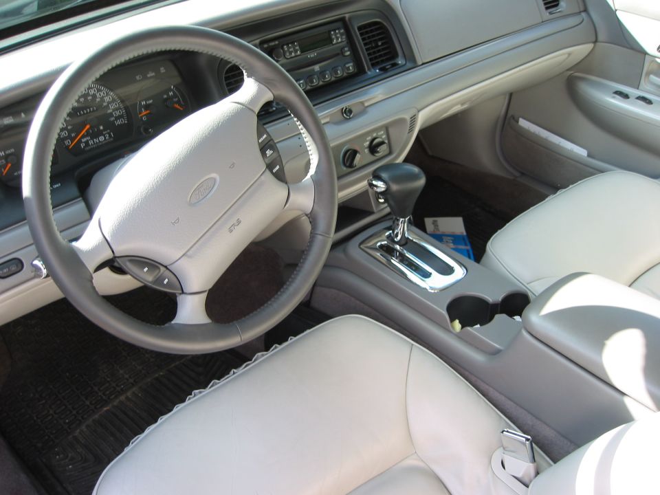 1996 Ford Crown Victoria interior showing steering wheel, dashboard, center console, and seats
