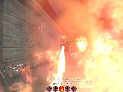 1988 Ford Bronco - A player uses a flamethrower in a hallway engulfed in flames, with game interface elements visible.