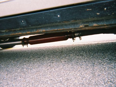 1990 Ford Crown Victoria LTD - Close-up of a vehicle's exhaust component, likely a muffler or resonator, mounted underneath.