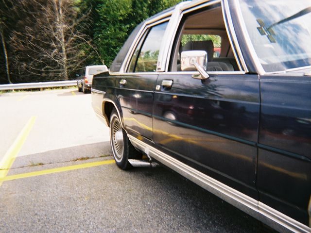 1990 Ford Crown Victoria LTD, side view, parked in a lot with another vehicle behind it