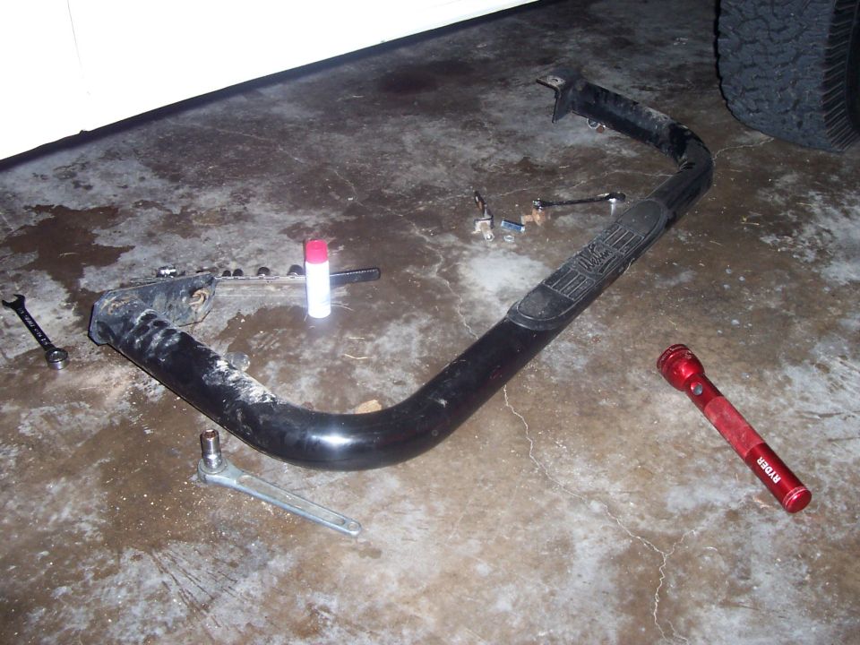 Black rocker panel slider with textured step pad and mounting hardware