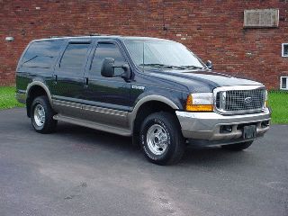 2000 Ford Excursion - 2000 Ford Excursion SUV, dark blue with tan lower body panels, parked outdoors.