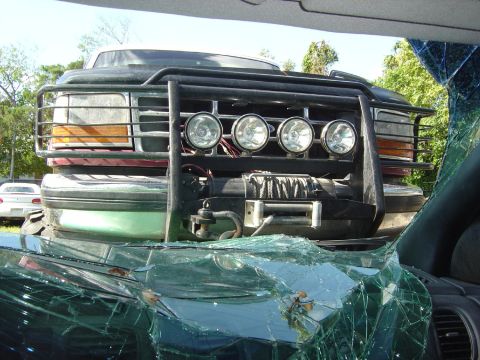 1993 Ford Bronco - This Ford Bronco has a damaged front end, including a broken windshield and a winch.