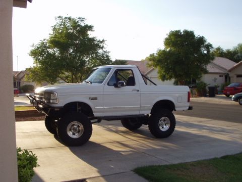 1993 Ford Bronco - This lifted 1993 Ford Bronco features an aftermarket front bumper and large off-road tires.