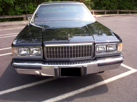 1991 Ford Crown Victoria LTD - This sedan has a prominent chrome grille and dual rectangular headlights.