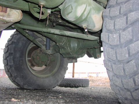 1981 Ford Bronco - Close-up of the undercarriage, showing the rear axle and suspension components of a heavy-duty vehicle.