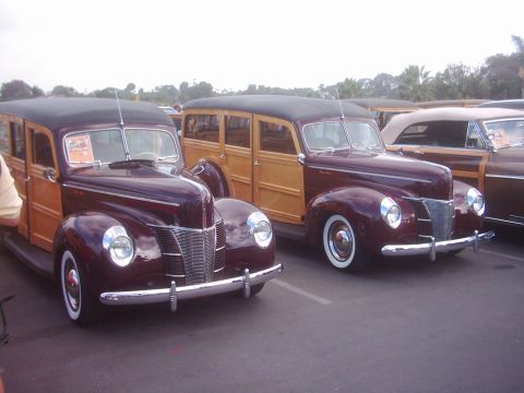 1978 Ford Bronco - A pair of vintage 1940 Ford woody station wagons are displayed at an outdoor event.