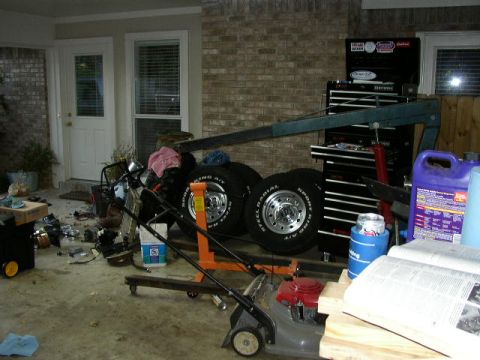 1995 Ford Bronco - Garage scene with an engine, tires, lawnmower, and tool chest.