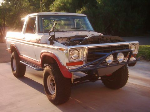 1978 Ford Bronco - This modified Ford pickup truck has an aftermarket bumper and a visible roll cage inside the cabin.