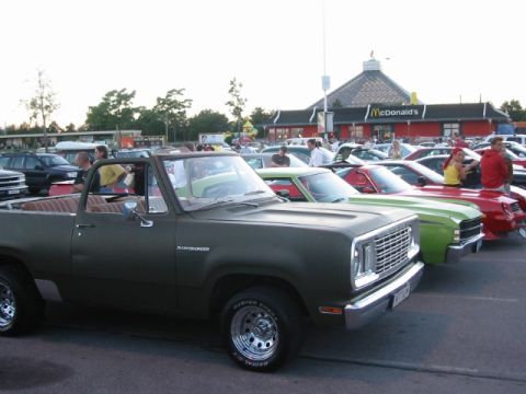 1992 Ford Crown Victoria - Dodge Ramcharger SUV at a car meet with McDonald's in the background.