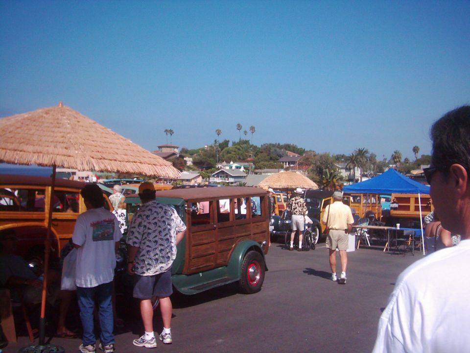 Woodie station wagon with green body and wooden panels, seen from the side