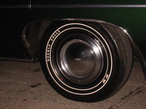 1992 Ford Crown Victoria - A close-up shot focuses on the wheel and tire of a Chevrolet vehicle, whitewall lettering.