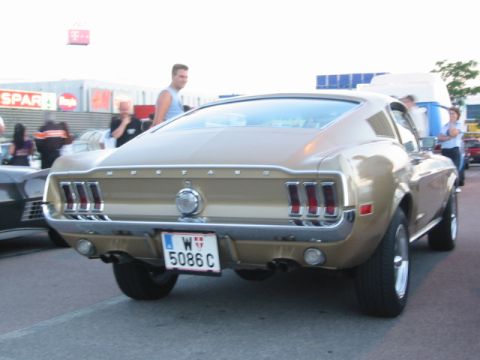 1992 Ford Crown Victoria - Rear view of a gold 1967 Ford Mustang fastback with a European license plate.