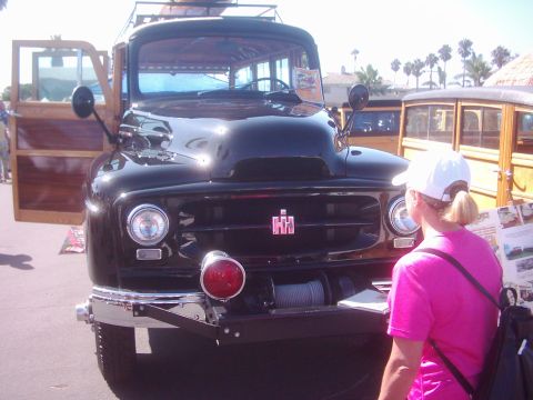 1978 Ford Bronco - A classic International Harvester truck with wood paneling is displayed outdoors, with another woodie vehicle in the background.