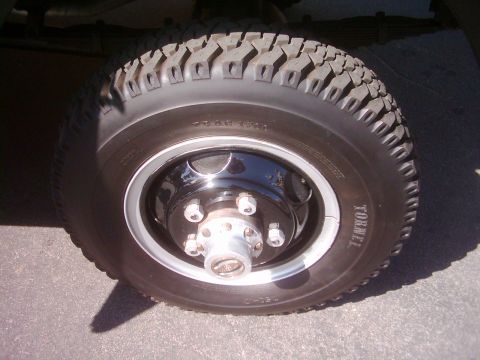 1978 Ford Bronco - Close-up of a vehicle wheel and tire assembly, showing tread pattern and sidewall details.