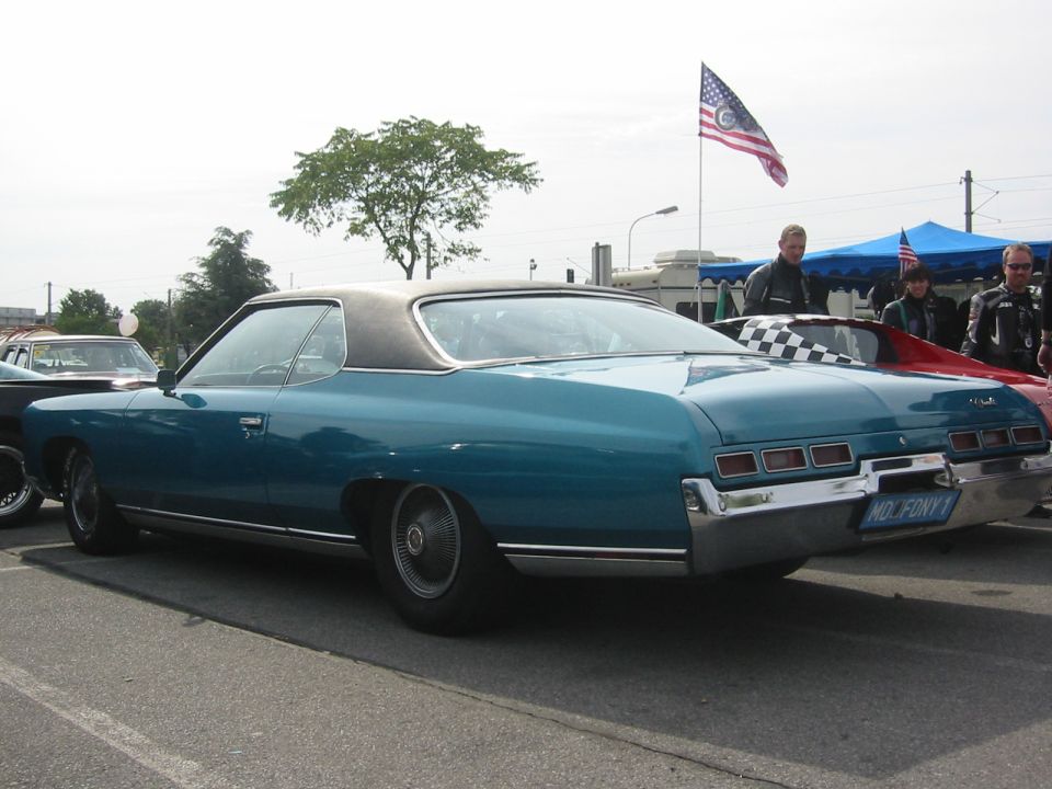 Teal 1971 Chevrolet Caprice coupe with black vinyl roof, parked outdoors. License plate reads 'MD. FONY 1'