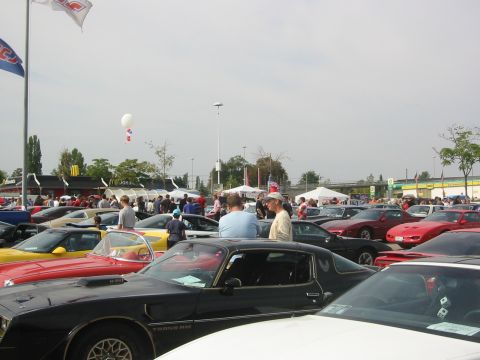 1992 Ford Crown Victoria - A gathering of vehicles and people at an outdoor event, with a variety of cars on display.