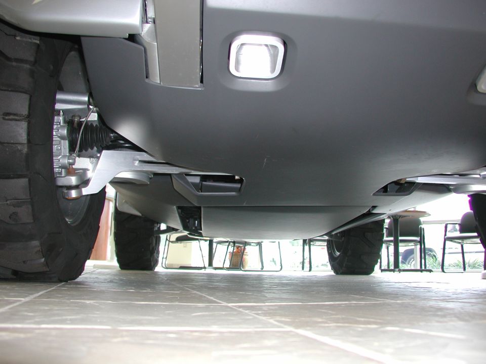 Underside view of a vehicle's suspension and large tires