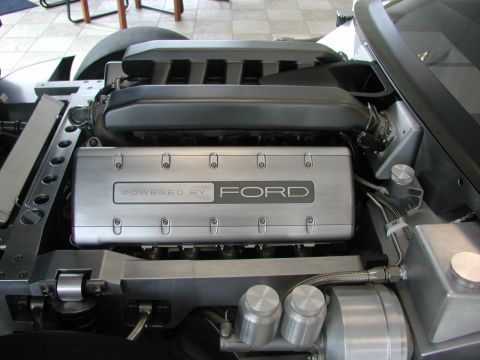 1985 Ford Bronco - Close-up view of a Ford engine bay, highlighting the "Powered by Ford" branding on the engine cover.