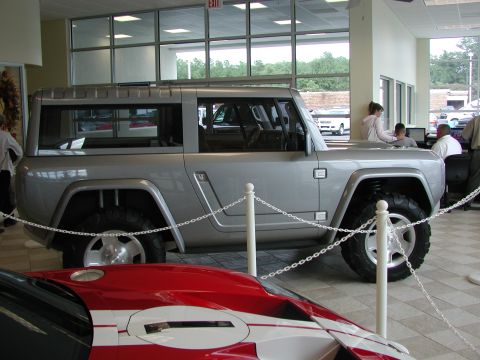 1985 Ford Bronco - Silver SUV concept vehicle on display indoors.