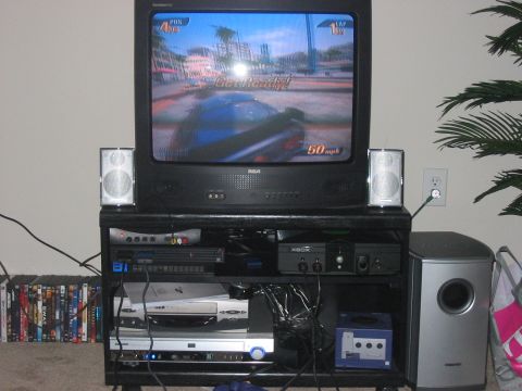 1988 Ford Bronco - A television displays a racing video game scene with a car and speed indicator.