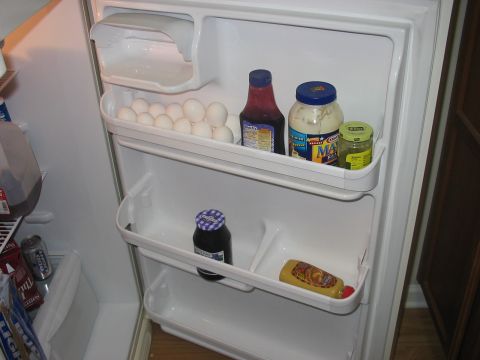 1988 Ford Bronco - Contents of a refrigerator include eggs, condiments, and beverages on shelves and door bins.