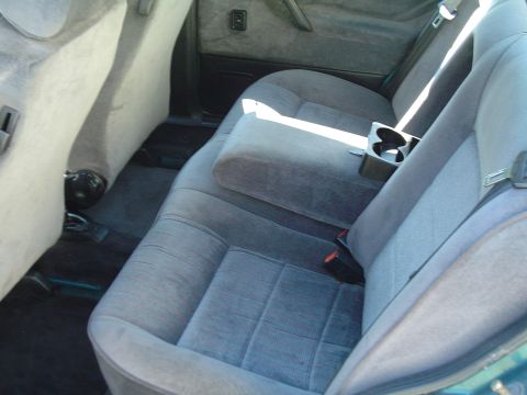 1992 Volkswagen Jetta - Rear interior view of a car, showing the seats and center console with cup holders.