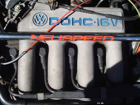 1992 Volkswagen Jetta - Close-up of a 1992 Volkswagen Jetta engine, highlighting the DOHC-16V valve cover and a NEUSPEED strut bar.