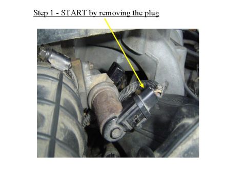 1993 Ford Bronco - Close-up of an engine sensor with a yellow arrow indicating removal. Text provides the first step of a procedure.
