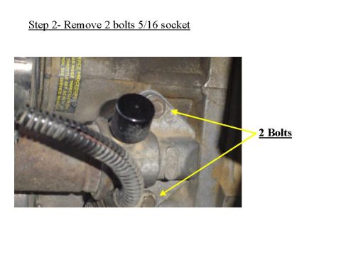 1993 Ford Bronco - This image shows the removal of two bolts from an engine component as part of a procedure.