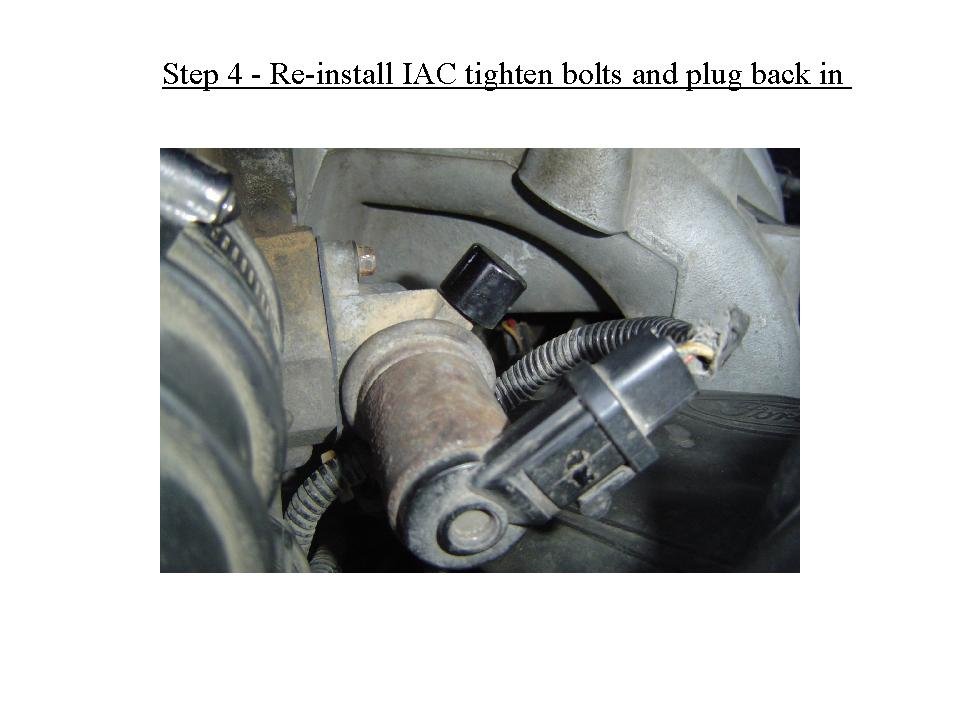 Engine bay close-up showing IAC valve, wiring connectors, and aluminum housing