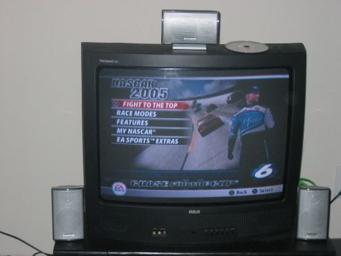 1988 Ford Bronco - A television displays the menu for the NASCAR 2005 video game, game options and a driver graphic.