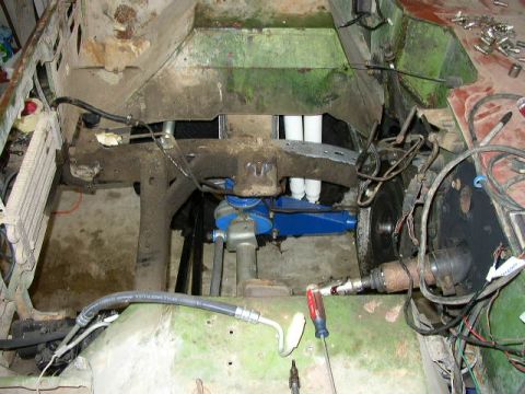 1995 Ford Bronco - Vehicle engine bay with parts removed and wiring exposed, indicating ongoing maintenance or repair work.