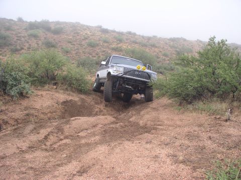 1990 Ford Bronco - This 1990 Ford Bronco navigates a steep, muddy incline in a dry, brushy landscape.