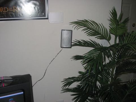 1988 Ford Bronco - A wall-mounted speaker is visible next to a potted plant and a framed poster.
