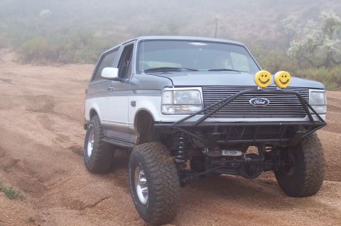 1992 Ford Bronco - This modified Ford Bronco is shown off-road with a custom front bumper and auxiliary lights.