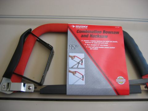 1985 Ford LTD Crown Victoria - A Husky Combination Bowsaw and Hacksaw package is shown with its red and black handles.