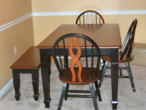 1985 Ford LTD Crown Victoria - A dining set a rectangular table, four chairs, and a bench, all with dark legs and wooden seats and backs.