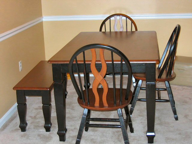 Dining table with four chairs and a bench