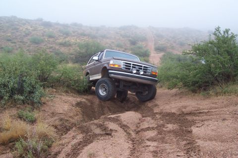1992 Ford Bronco - This 1992 Ford Bronco tackles a challenging off-road trail with its front wheels elevated.