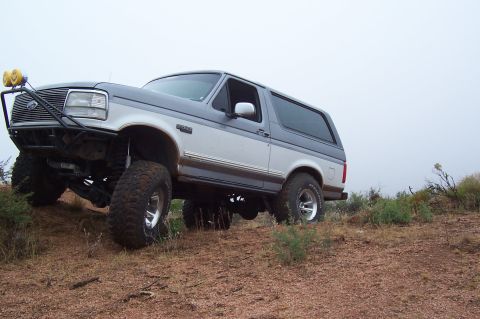 1992 Ford Bronco - This lifted 1992 Ford Bronco is shown navigating a dirt incline.