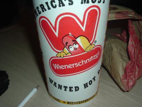 1993 Ford Taurus - A close-up of a Wienerschnitzel cup with its mascot and slogan is shown on a table.