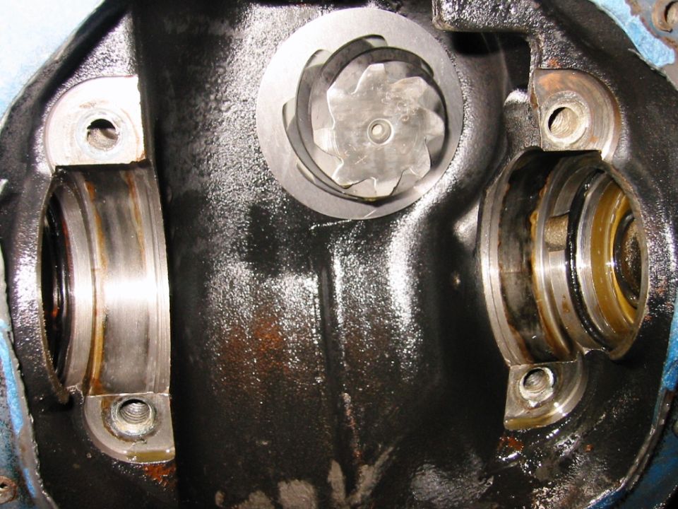 Open differential housing showing carrier bearing bores and pinion gear