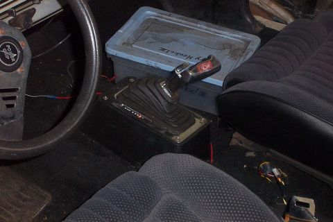 1966 Ford Fairlane - Interior view of a car's floor shifter and seats, with some visible text on the shifter handle.