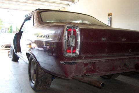 1966 Ford Fairlane - Rear view of a maroon 1966 Ford Fairlane showing the taillight and quarter panel.