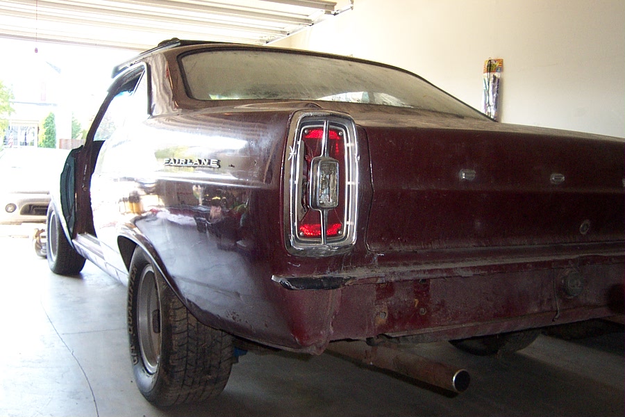 1966 Ford Fairlane rear quarter panel, taillight, and bumper in a garage